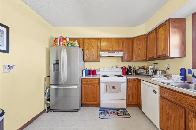 a kitchen with a refrigerator and a sink