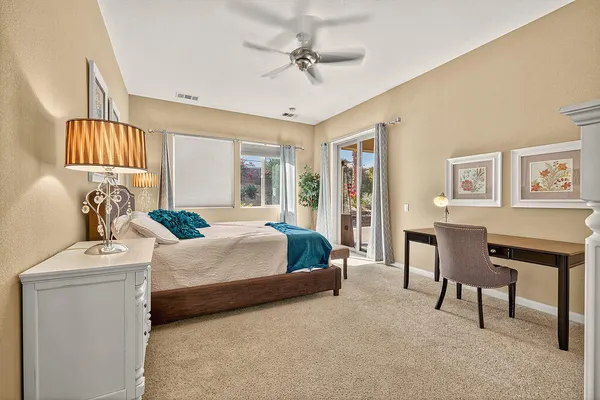 a bedroom with a bed a couch and dresser