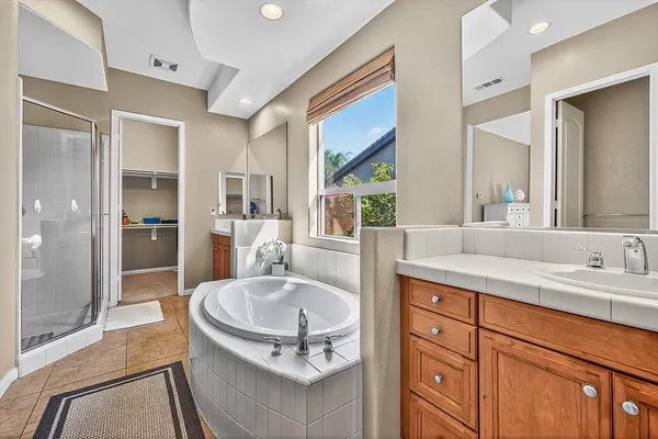 a bathroom with a granite countertop sink mirror and shower