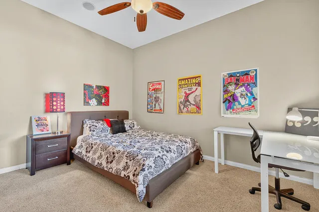 a bedroom with a bed and a desk