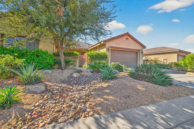 a front view of a house with a yard and a garage