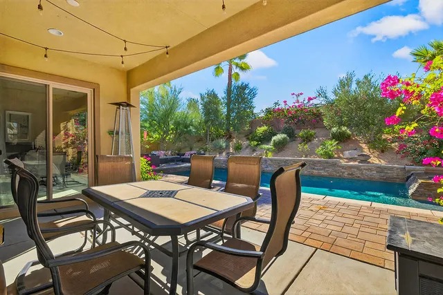 a view of a patio with a table and chairs