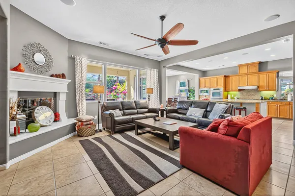 a living room with furniture a flat screen tv and a fireplace