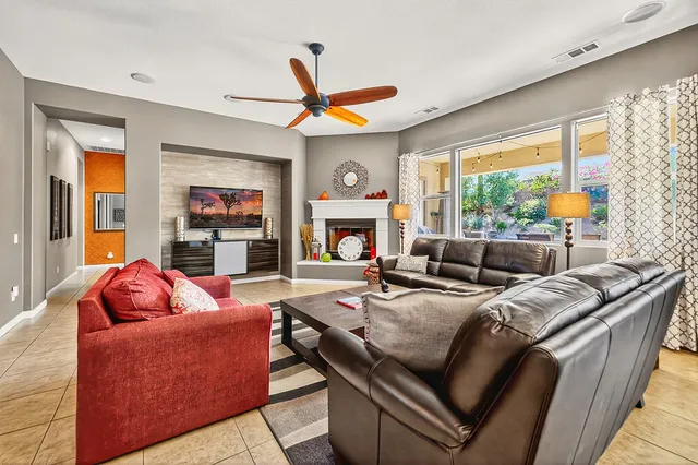 a living room with fireplace furniture and a flat screen tv