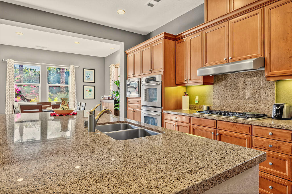 35831 Raphael Drive Palm Desert, CA 92211 - Photo 8 of 24 a kitchen with stainless steel appliances granite countertop a sink stove and cabinets