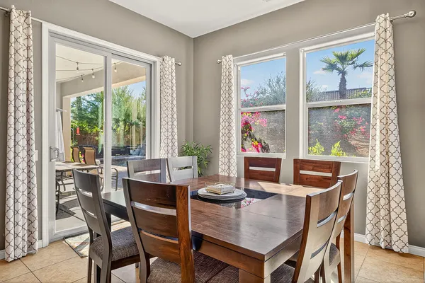 a dining room with furniture and window