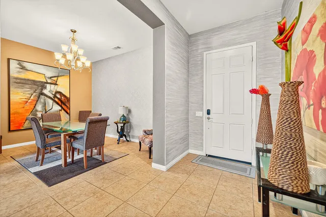 a view of a dining room with furniture and a chandelier