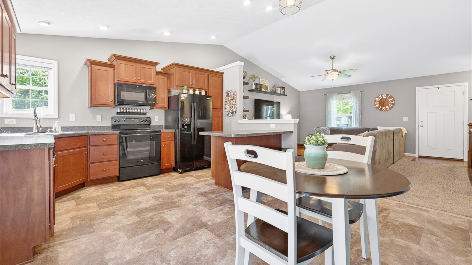 308 East Locust Street Normal, IL 61761 - Photo 9 of 40 a kitchen with stainless steel appliances granite countertop a stove a sink a refrigerator dining table and chairs
