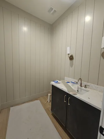 a view of a room with a chandelier fan and windows