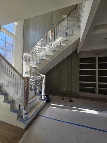 a living room with a fireplace and a ceiling fan