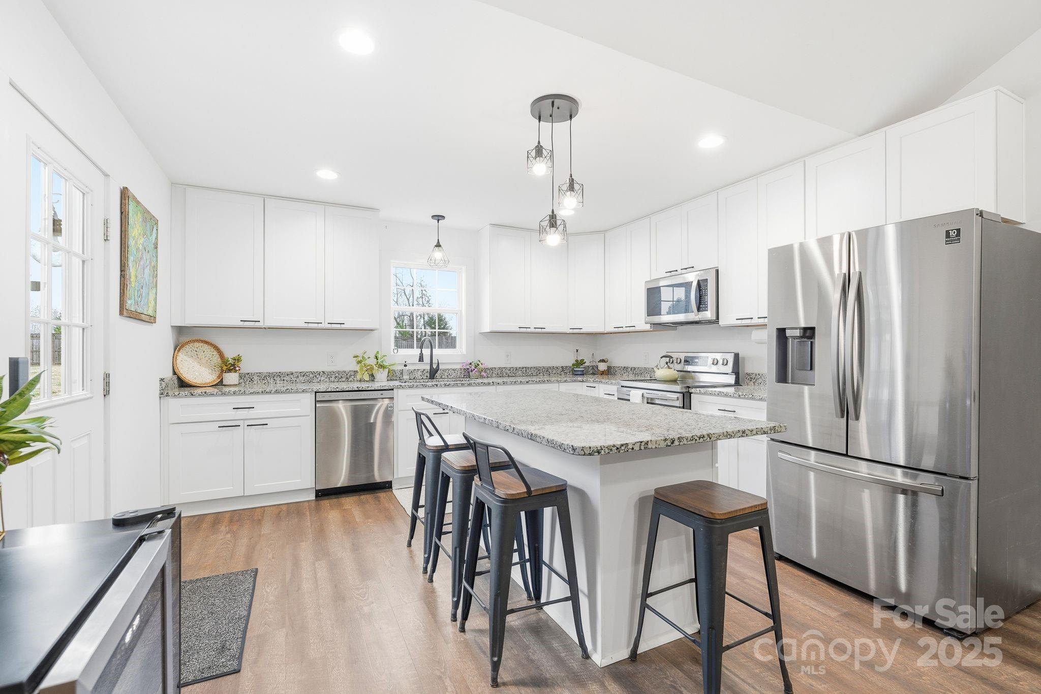 585 Stirewalt Road China Grove, NC 28023 - Photo 12 of 30 a kitchen with granite countertop a sink appliances a counter space and cabinets