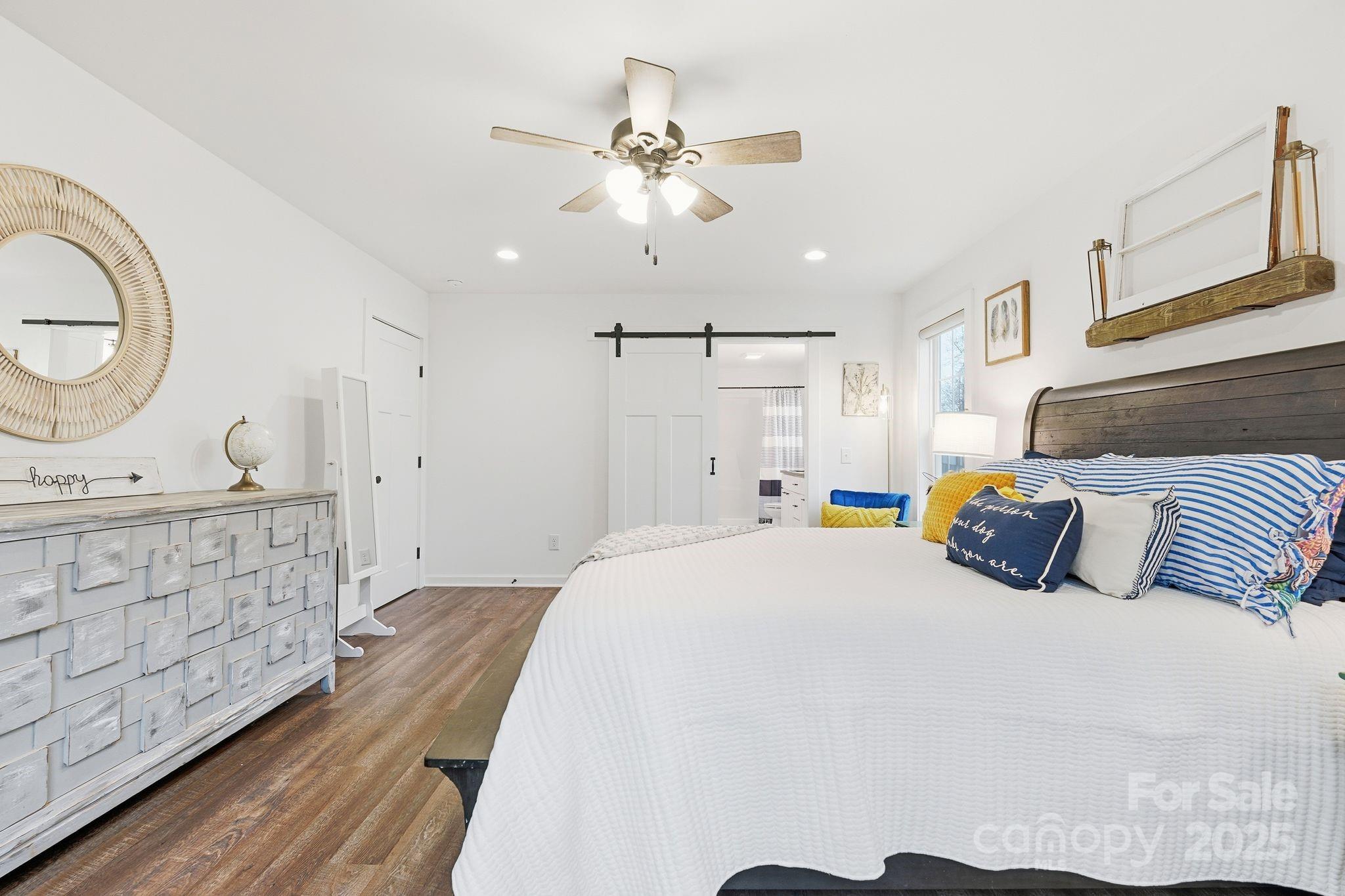585 Stirewalt Road China Grove, NC 28023 - Photo 18 of 30 a bedroom with a bed a chandelier and a dresser