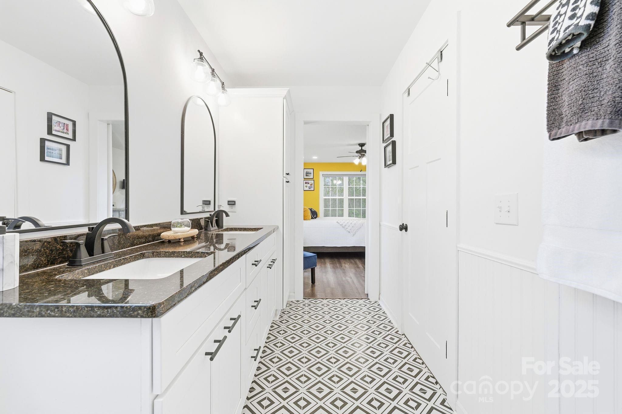 585 Stirewalt Road China Grove, NC 28023 - Photo 21 of 30 a en suite bathroom with a granite countertop sink and a mirror