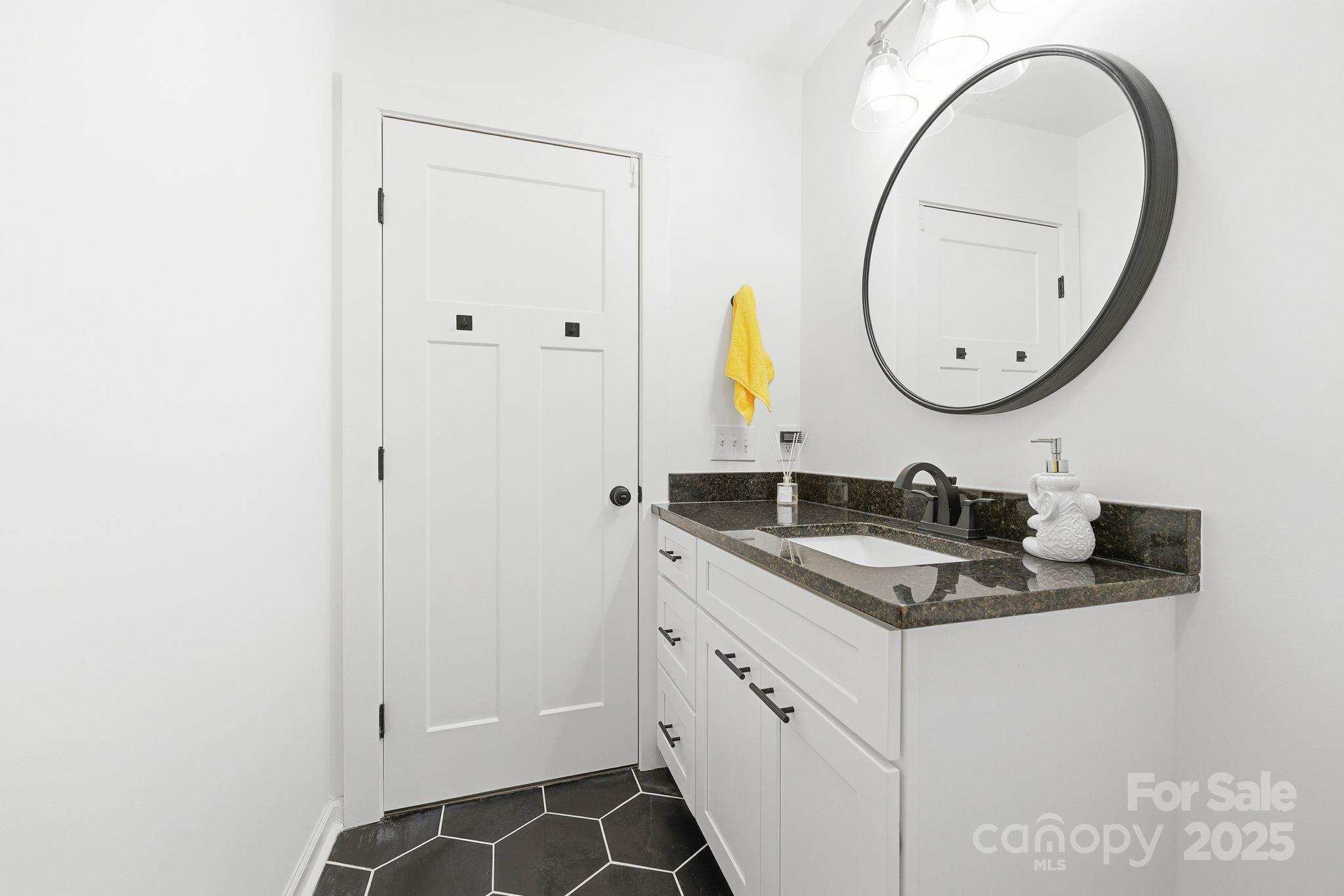 585 Stirewalt Road China Grove, NC 28023 - Photo 27 of 30 a bathroom with a granite countertop sink and a mirror