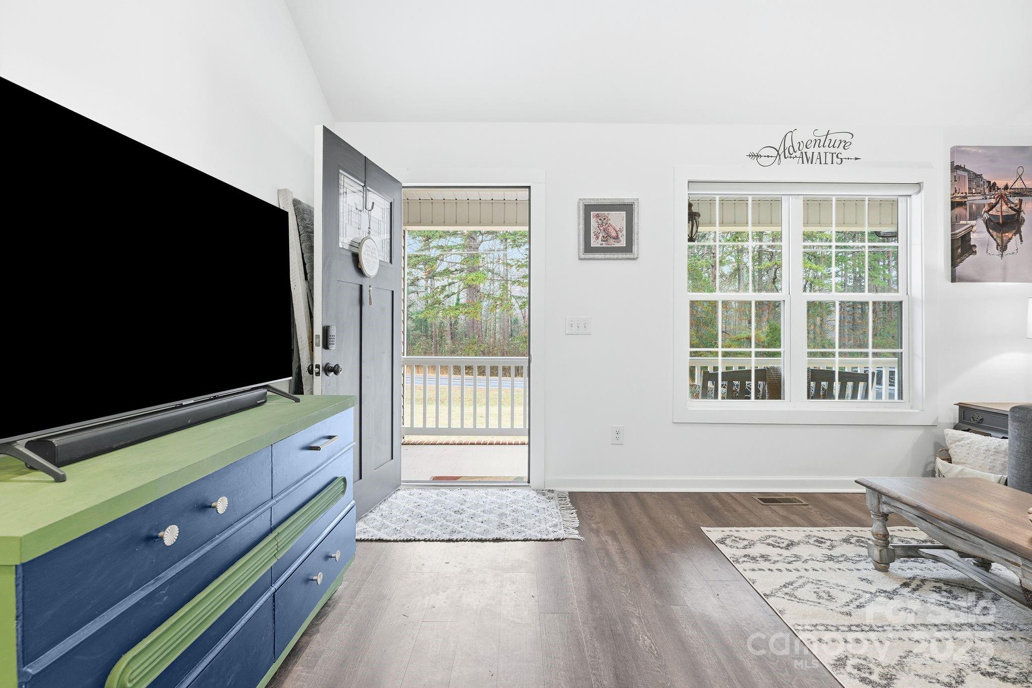 585 Stirewalt Road China Grove, NC 28023 - Photo 7 of 30 a living room with a flat screen tv and a floor to ceiling window