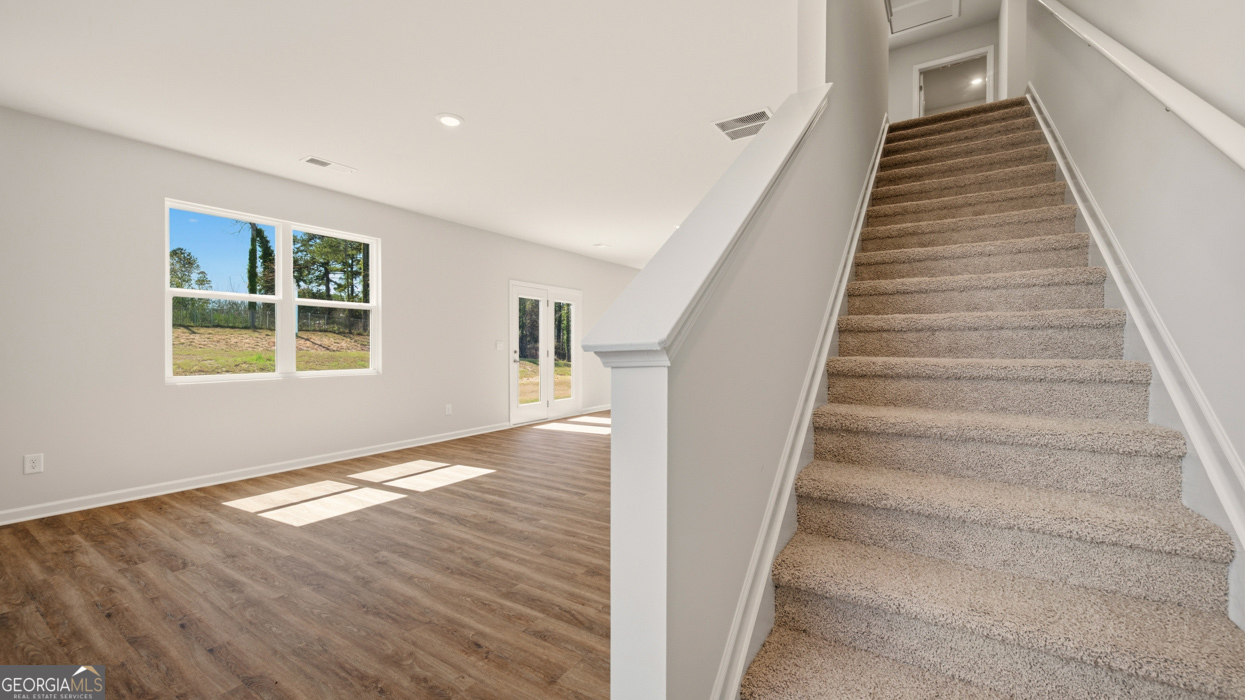 8578 Seabiscuit Road Lithonia, GA 30058 - Photo 17 of 30 a view of an entryway with wooden floor and stairs