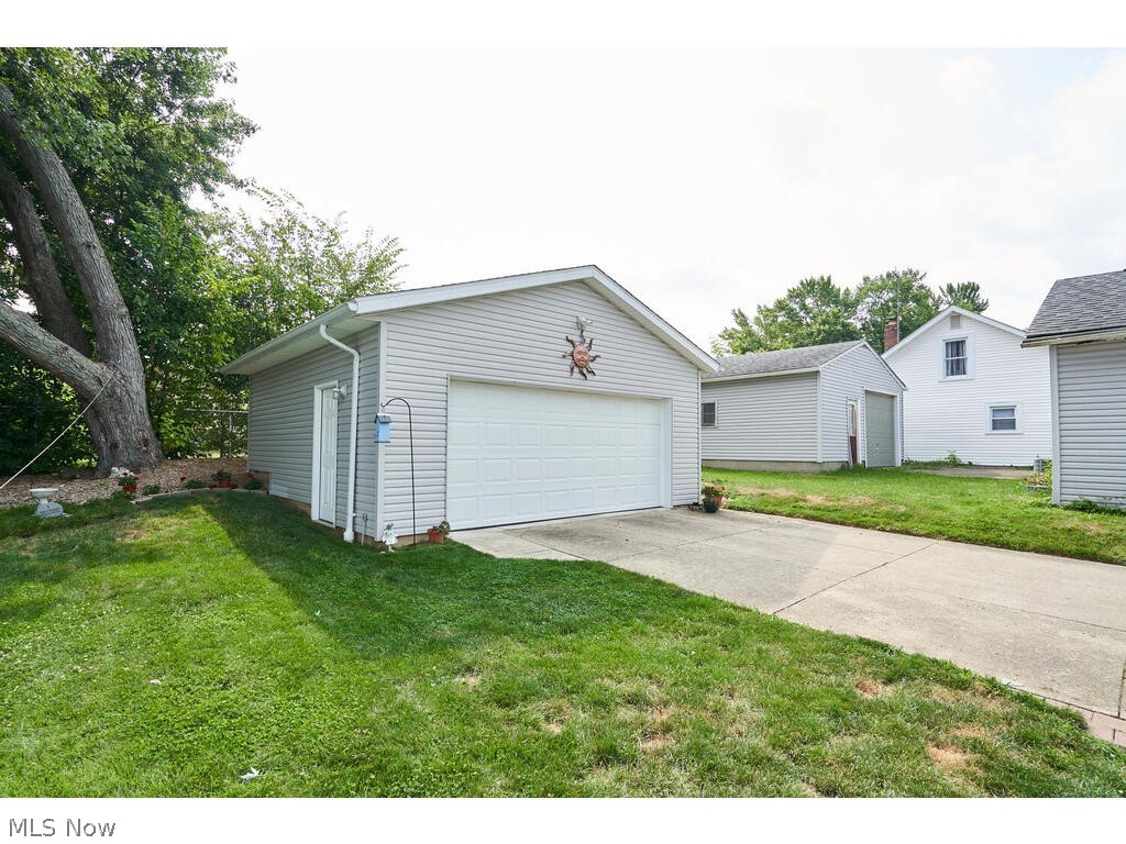 323 Ripley Avenue Akron, OH 44312 - Photo 23 of 25 Garage featuring a lawn