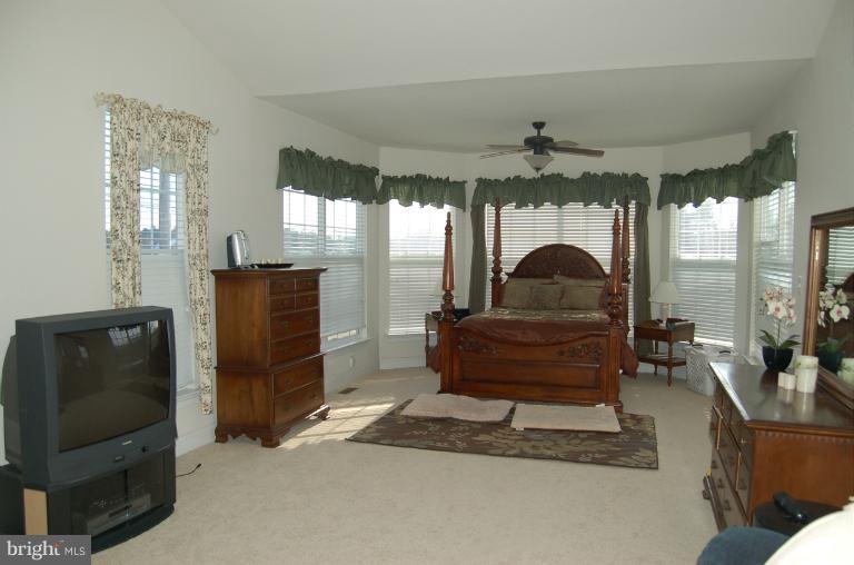 8312 Banister Road Severn, MD 21144 - Photo 11 of 21 a living room with furniture a ceiling fan and a flat screen tv