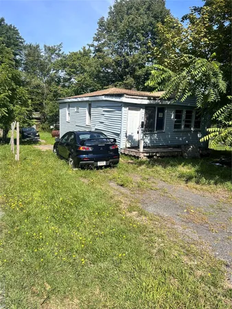 a view of a house with backyard and sitting area