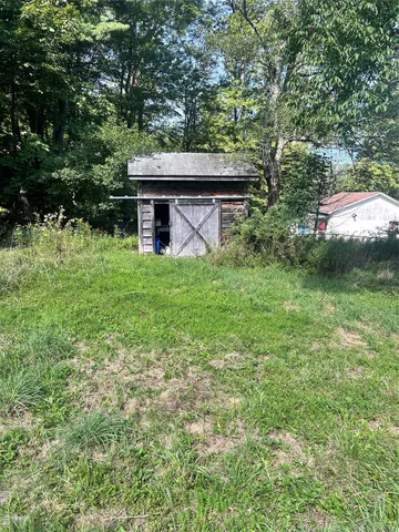 a view of a house with a backyard