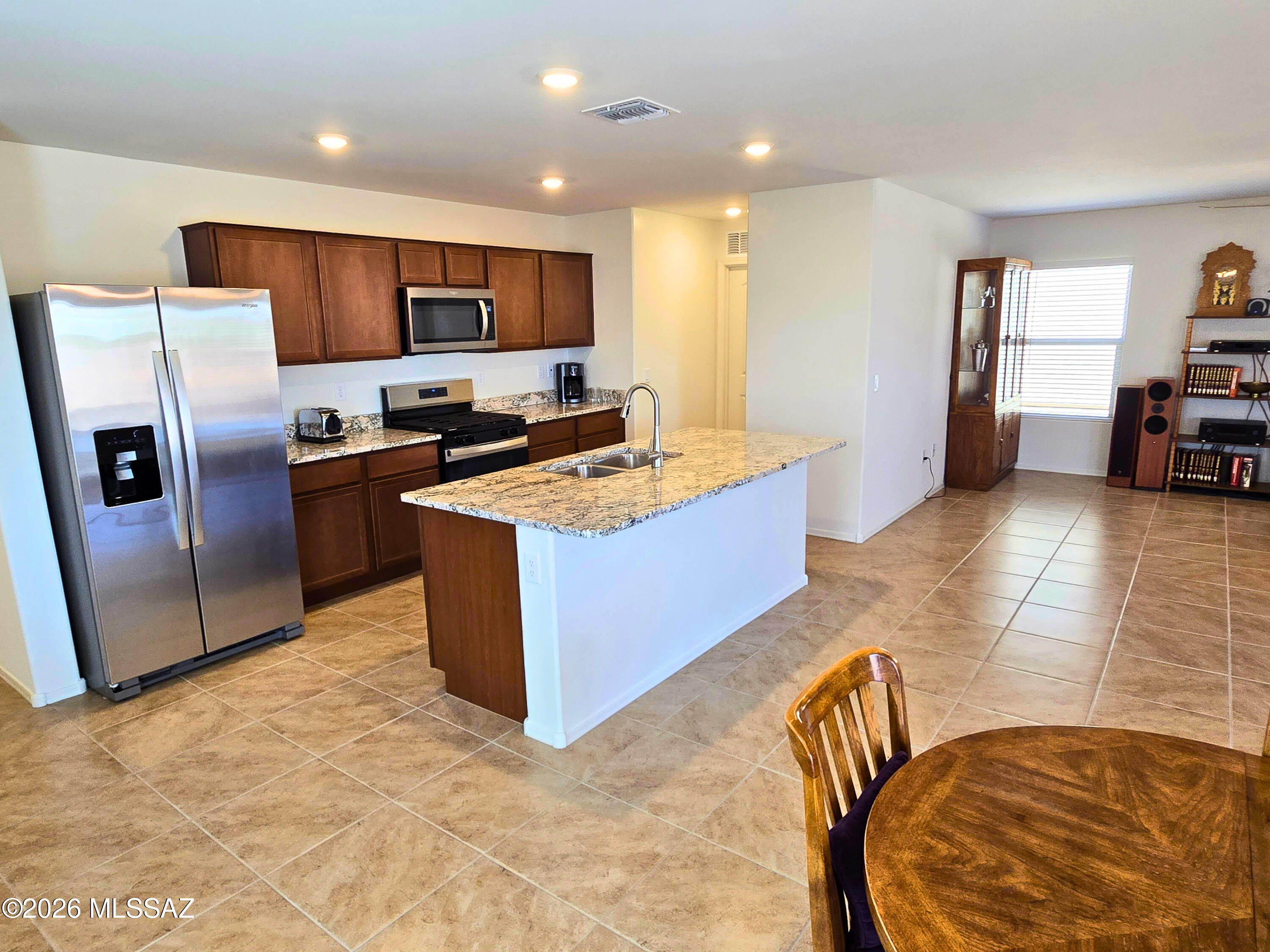 6343 South Rigby Way Tucson, AZ 85746 - Photo 6 of 29 a kitchen with stainless steel appliances granite countertop a stove refrigerator and a sink