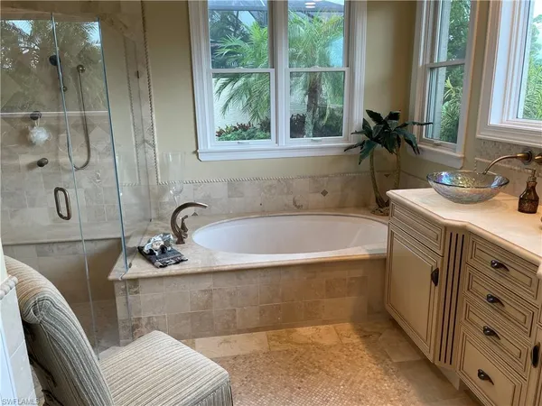 a bath tub sitting next to a bathroom sink