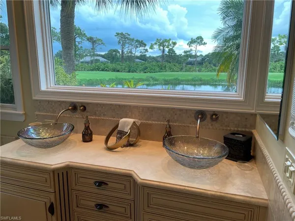 a kitchen with a sink and a large window