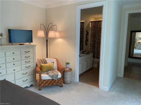 a bedroom with a bed and a television