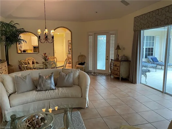 a living room with furniture and a chandelier