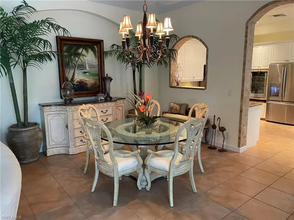 a dining room with furniture and chandelier