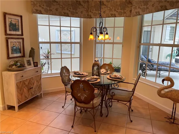 a view of a dining room with furniture and window