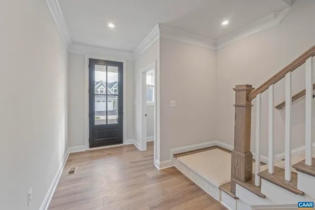 a view of entryway with wooden floor and stairs