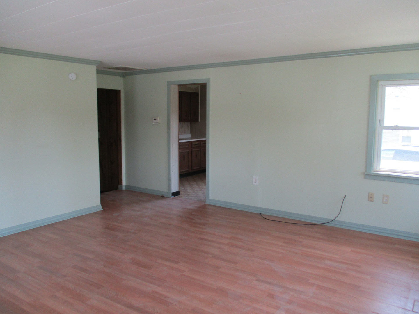 3344 East 2059th Road Ottawa, IL 61350 - Photo 8 of 17 a view of an empty room with wooden floor and a window