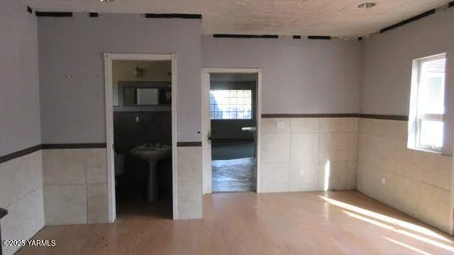 a bathroom with a sink a window and a shower