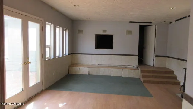 a view of a small space with wooden floor and a window