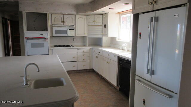 1116 Meadowbrook Road Yakima, WA 98903 - Photo 6 of 23 a kitchen with stainless steel appliances a refrigerator sink and cabinets