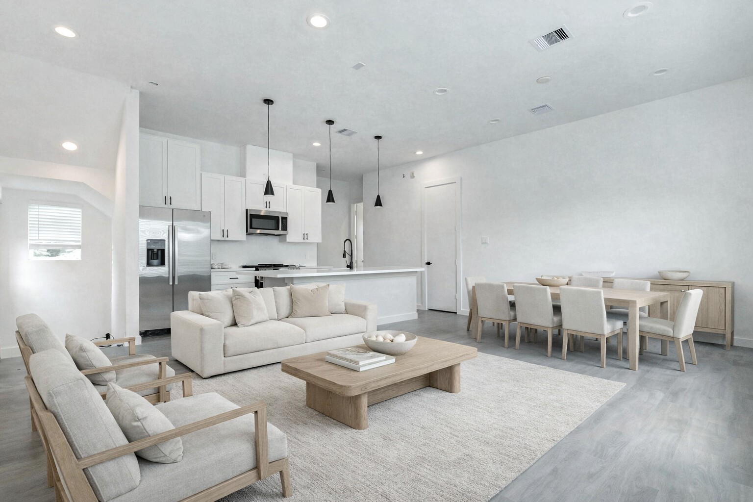 6017 Beall Street Houston, TX 77091 - Photo 4 of 33 Open-concept living at its finest! Enjoy seamless flow between kitchen, dining, and living spaces, anchored by luxe vinyl plank flooring and high-end lighting throughout. This photo has been virtually staged for visual reference.