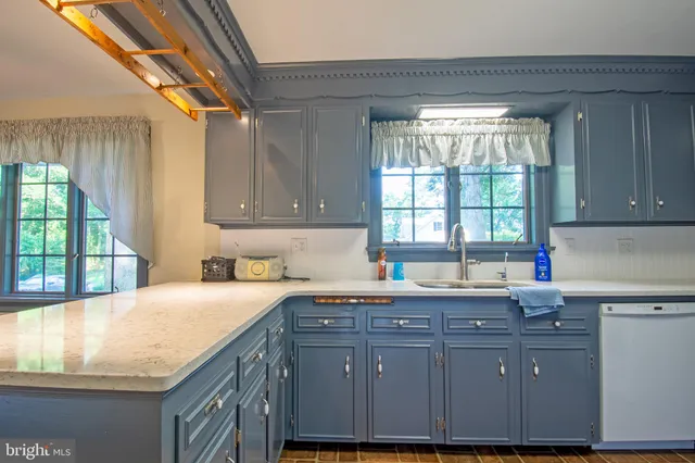 a kitchen with stainless steel appliances granite countertop a sink and a wooden cabinets