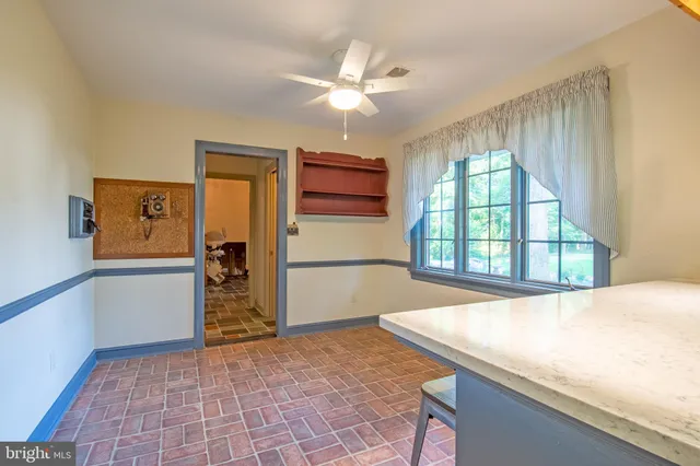 a dining room with a sink a table and chairs