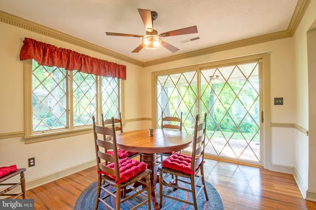 a dining room with furniture and wooden floor