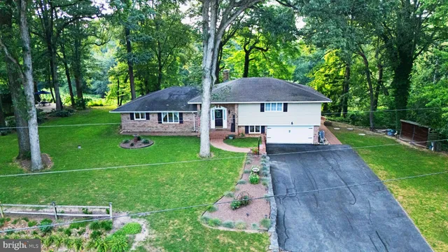 a view of house with backyard and outdoor seating