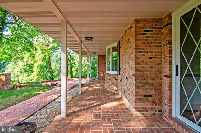a view of a patio with table and chairs under an umbrella