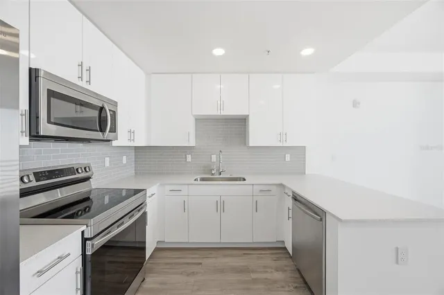 a kitchen with a sink stove and microwave