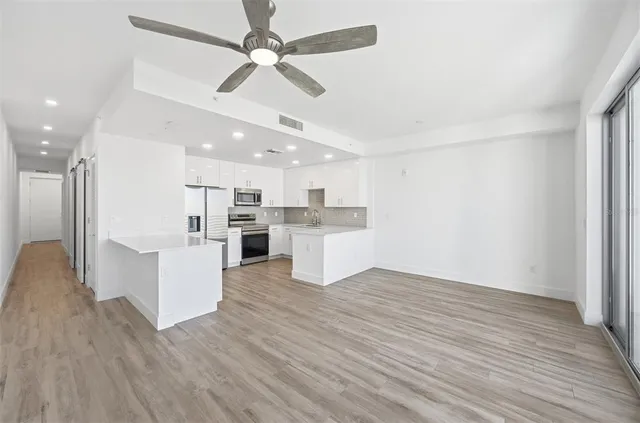 a view of kitchen with wooden floor and window