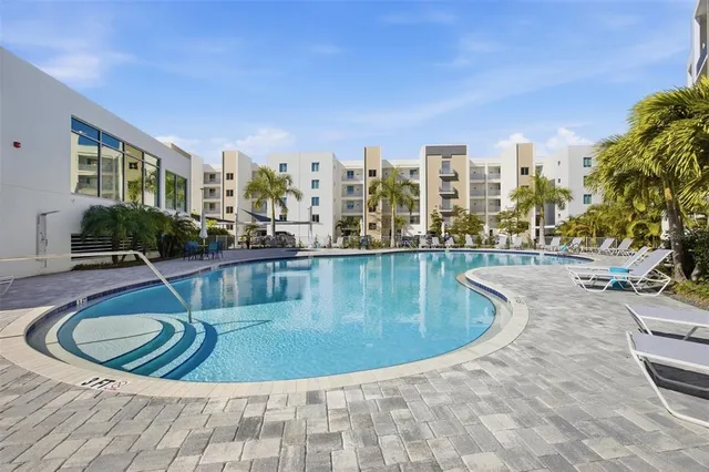 a swimming pool with outdoor seating and yard