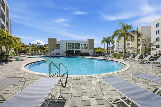 a view of swimming pool with outdoor seating and plants