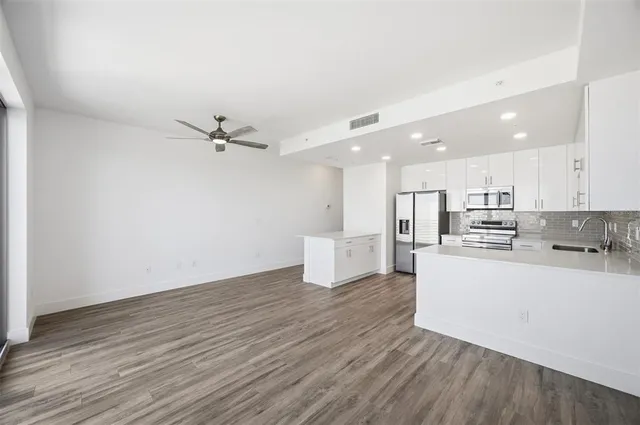 a view of kitchen with sink and wooden floor