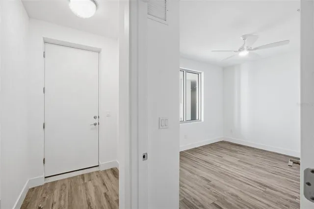 a view of room with window and wooden floor