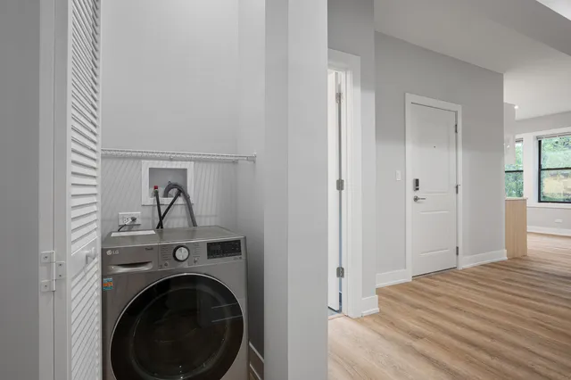 a view of a bedroom with washer and dryer