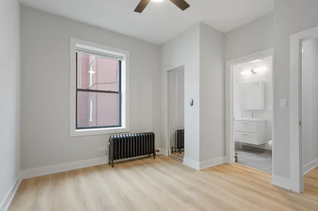 an empty room with windows and closet